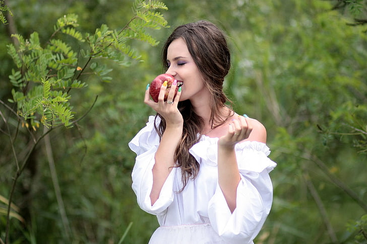 woman biting apple fruit