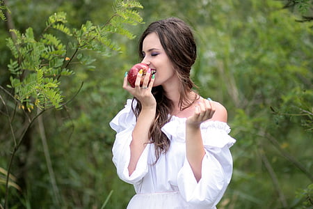 woman biting apple fruit