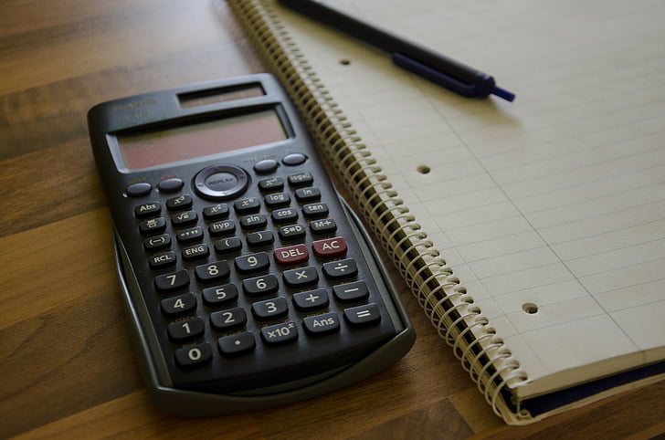 Royalty-Free photo: Black graphing calculator beside spiral note book - PickPik