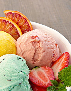 ice cream surrounded with slice strawberry and orange