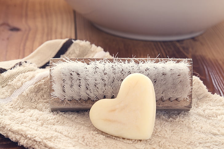 closeup photo of heart white soap and brush