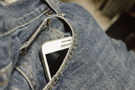white Samsung smartphone inside the pocke