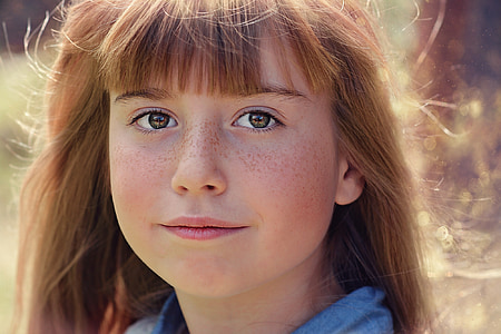 focus photo of girl in blue top