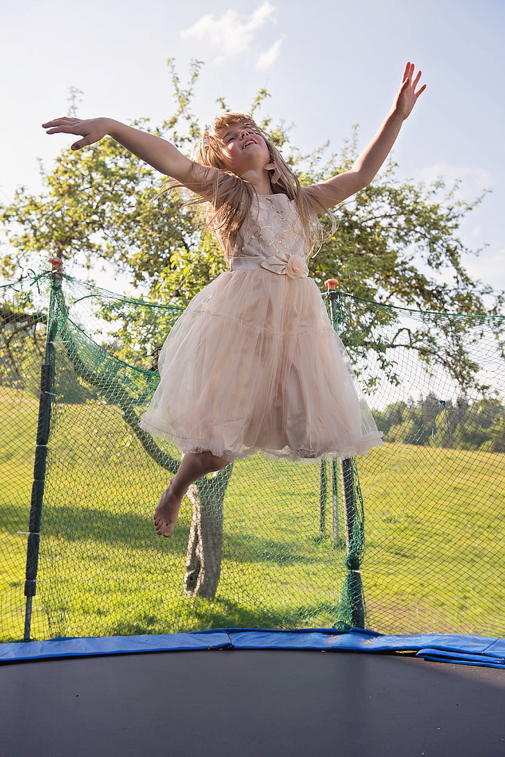 Baby Girl Jumping On Trampoline Stock Photo, Picture and Royalty