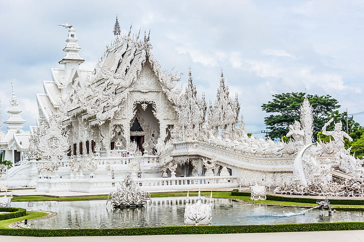 photo of white temple near body of water