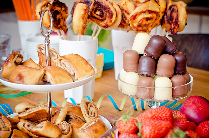 variety of pastries and strawberries on table