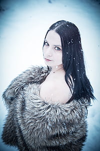 woman in brown coat standing on snow