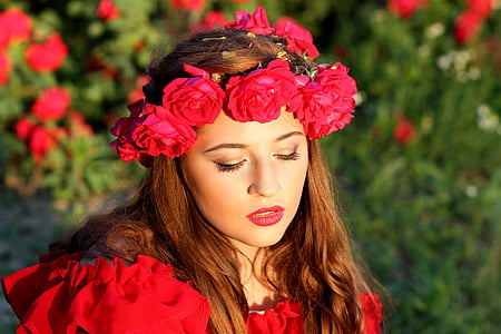 woman wearing red top and flower headdress