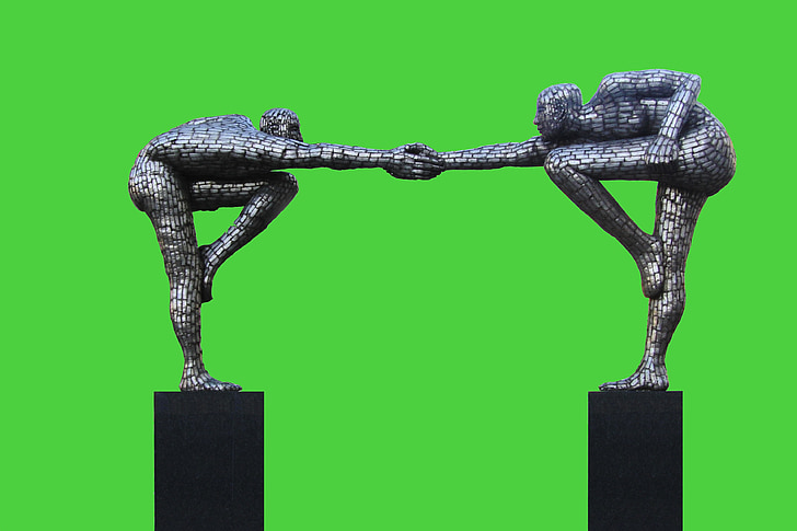 photo of two men holding hands figurine