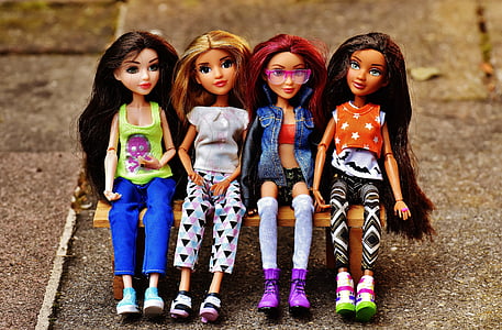 four dolls miniatures sitting on bench toy