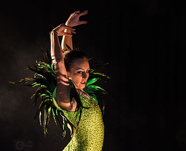 woman wearing green satin dress dancing