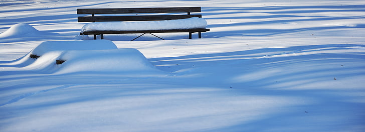 bench surrounded by snow
