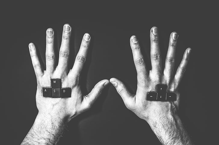painting of eight keyboard keys on human hands