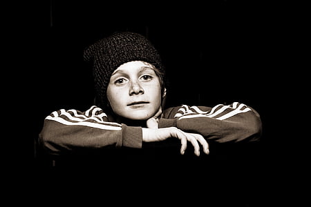 photo of boy in black knit cap and brown long-sleeved top