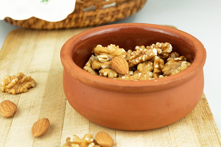 photo of brown almond brittles in brown clay pot
