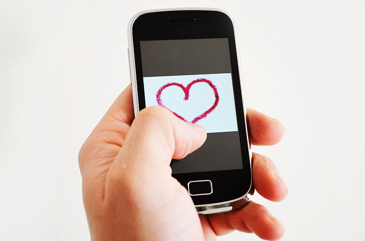 black smartphone showing red heart illustration