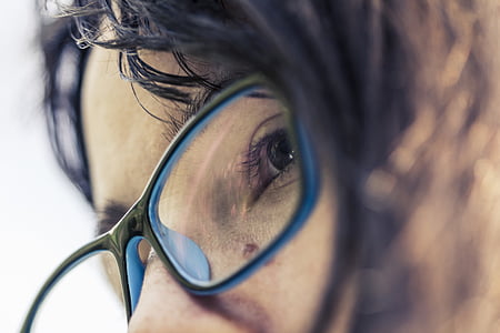 selective focus photo of woman wearing black framed eyeglasses