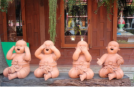 four brown ceramic babies figurines