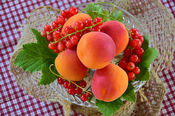 peach fruit on glass bowl