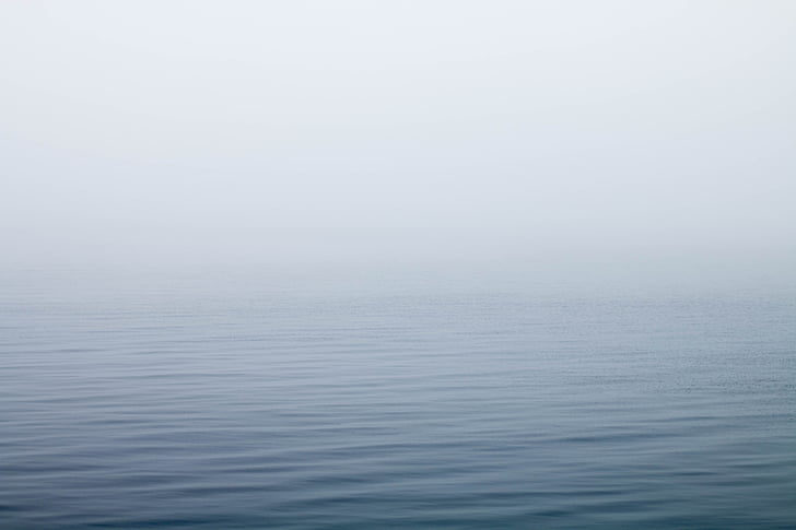 calm ocean water with fog