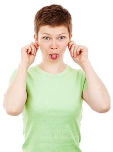 woman holding both hear ears and sticking her tongue out