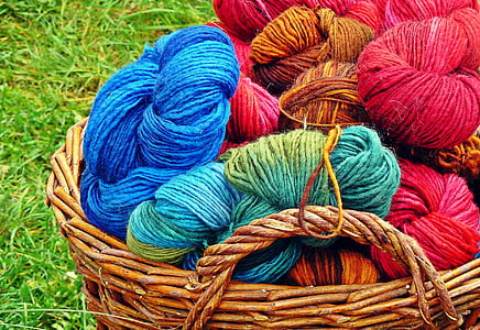 assorted-colored yarns in basket