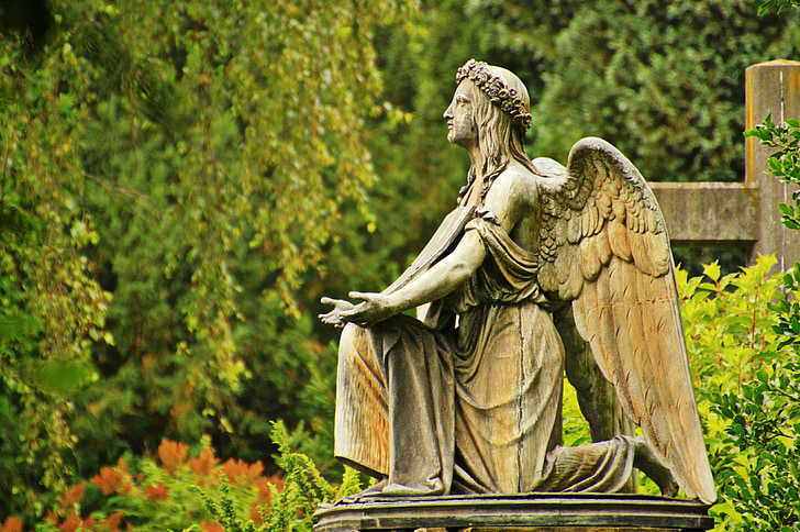 female angel statue near green trees
