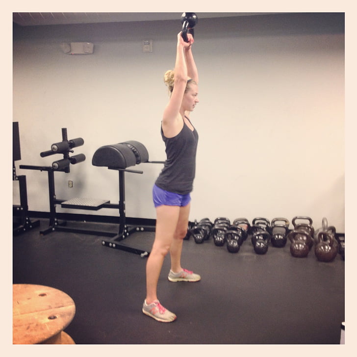 woman lifting a kettle bell