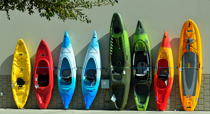 eight assorted-color kayaks