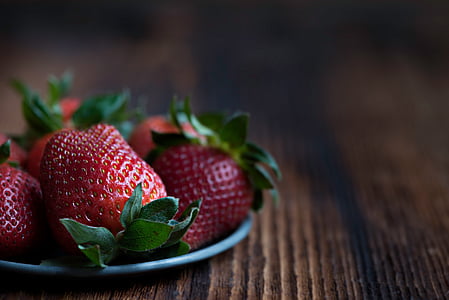 strawberries on silver saucer tilt shift lens photography