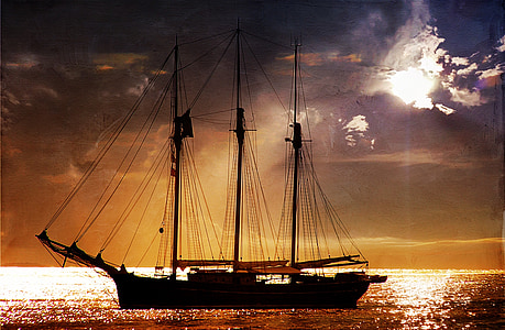 silhouette photography of ship on body of water