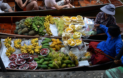assorted fruits on boats at daytime