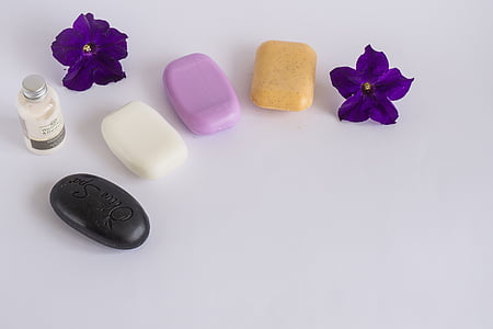 four assorted-color soaps on white surface