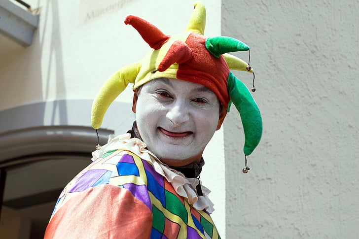person in clown costume near wall