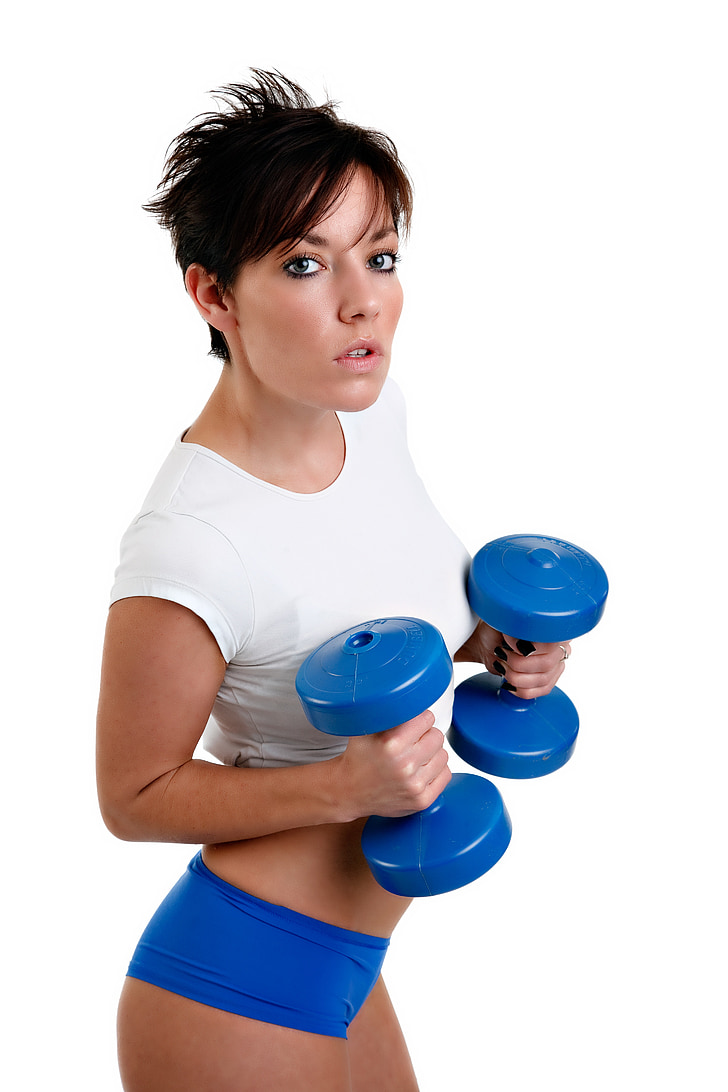 woman holding pair of blue dumbbells