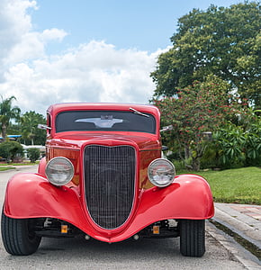 red classic car on roadside