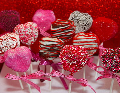 assorted-color coated chocolate pop lot on top of white surface