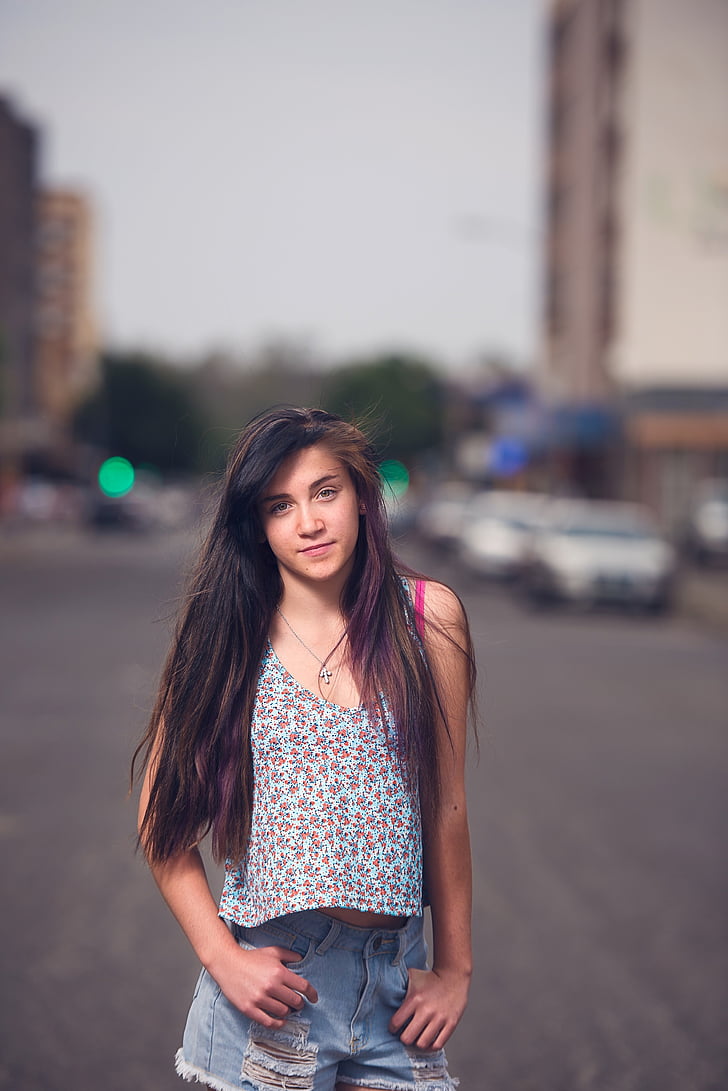 photo of woman standing on road