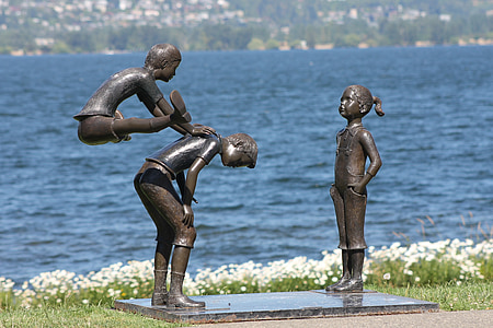 three children playing statue