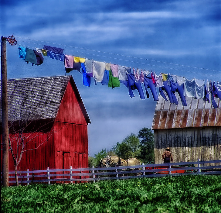 assorted-color clothes hanging on wire in daytime