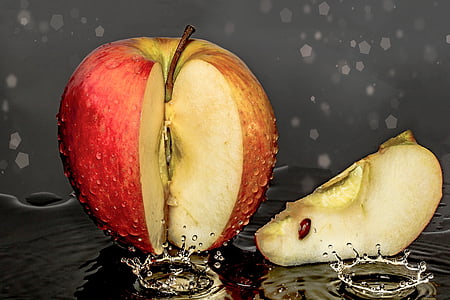 red slice of Apple with water drop
