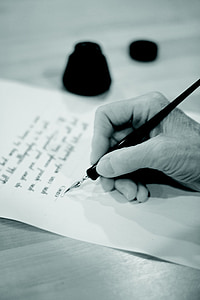 person using ink pen while writing