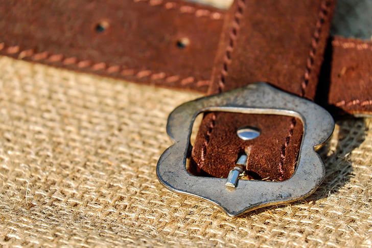 brown leather belt with silver-colored buckle