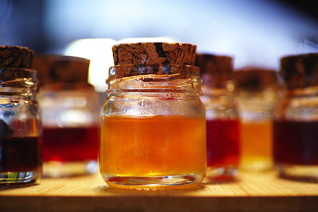 clear glass jar with orange liquid