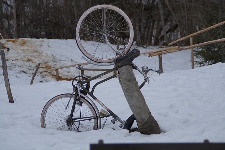 person biking buried in snow