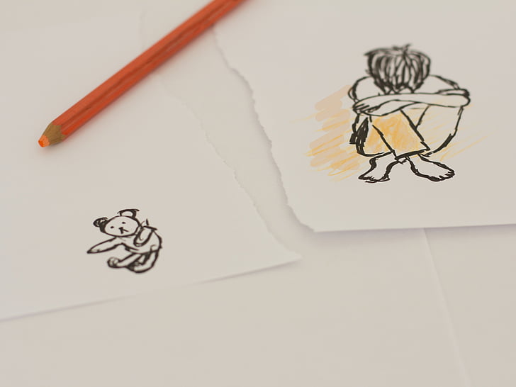boy sitting hand drawn sketch on torn paper