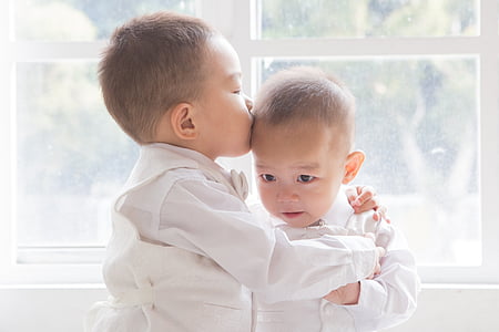 toddler kissing toddler in daytime
