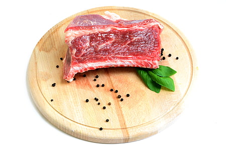 sliced meat on round brown chopping board