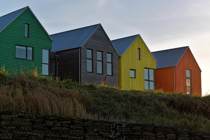 four assorted-color houses