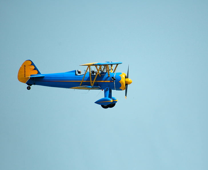 closeup photo of blue and yellow plane